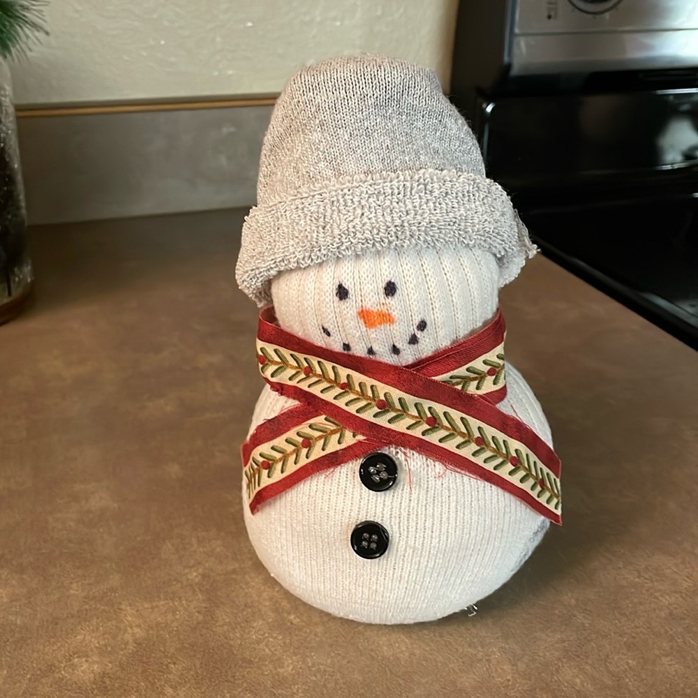 Made out of an athletic white sock. This homemade snowman -absolutely adorable.